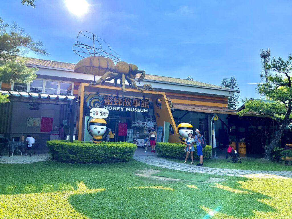 the exterior of the honey museum, the sun shiing bright on top