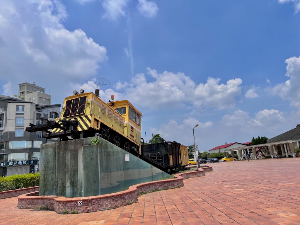 the view from outside yunlin train station- an old, retired yellow train on display